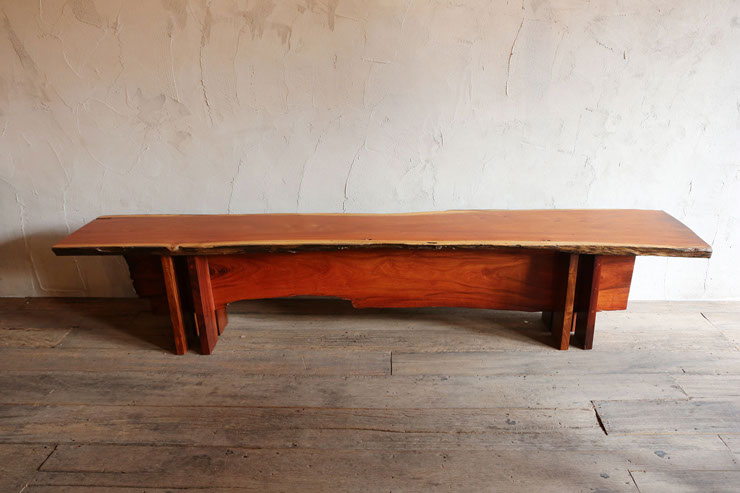 image of a long timber bench seat designed by vachira tongrow from his "if i were a carpenter" collection top remains with bark edges