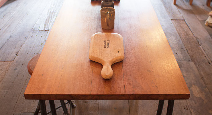 image from if i were a carpenters studio of a dining table with a timber top and metal legs. designed by vachira tongrow