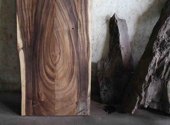 image of rough sawn asian walnut timber in the early stages of being made into a table top.